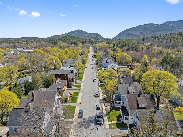aerial overview of property's location with a mountainous background and nearby suburban area