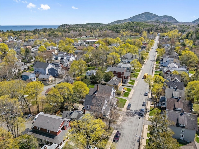 aerial view of property's location with nearby suburban area and a mountainous background