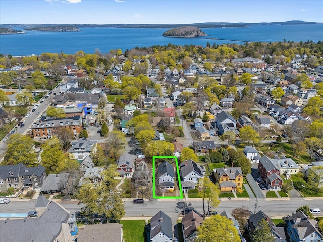 view of property location with nearby suburban area, property parcel outlined, and a nearby body of water