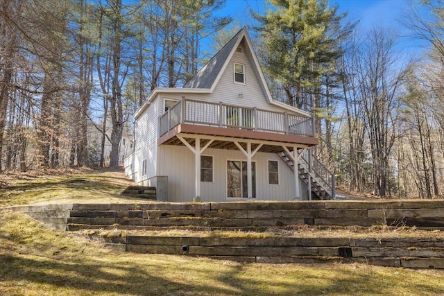 back of house with a wooden deck and stairway