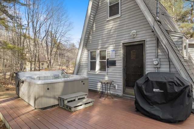 wooden terrace featuring a hot tub and a grill
