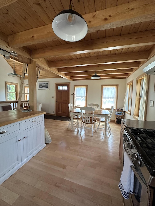 1157 Back Cv, Waldoboro, ME 04572 - kitchen featuring wooden ceiling, stainless steel range with gas cooktop, plenty of natural light, white cabinets, and light wood-type flooring