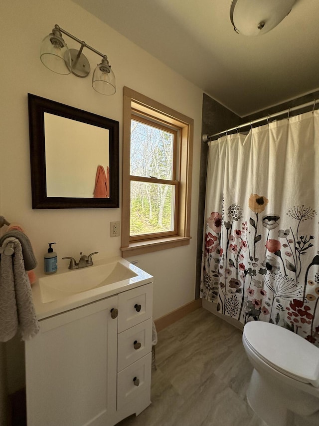 1157 Back Cv, Waldoboro, ME 04572 - bathroom with toilet, vanity, baseboards, and curtained shower