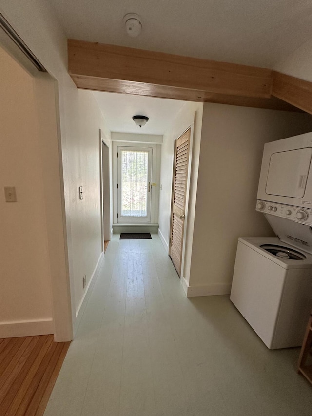 1157 Back Cv, Waldoboro, ME 04572 - corridor with stacked washer and clothes dryer, baseboards, light wood-type flooring, and beamed ceiling