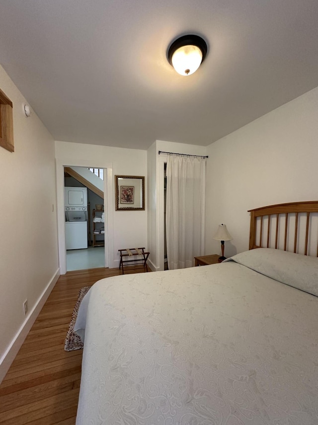 1157 Back Cv, Waldoboro, ME 04572 - bedroom featuring washer / clothes dryer, wood finished floors, and baseboards