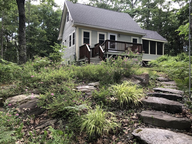 1157 Back Cv, Waldoboro, ME 04572 - view of front of property featuring roof with shingles, a wooden deck, and a sunroom