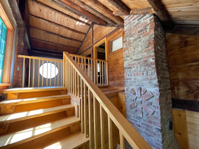 staircase featuring wood ceiling and wood walls