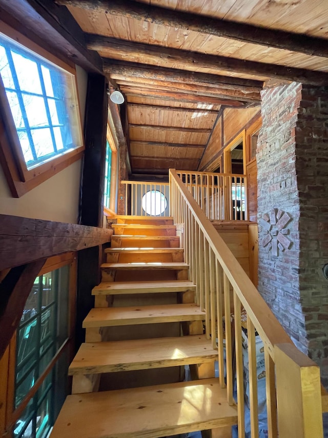 stairs with wooden ceiling and beamed ceiling