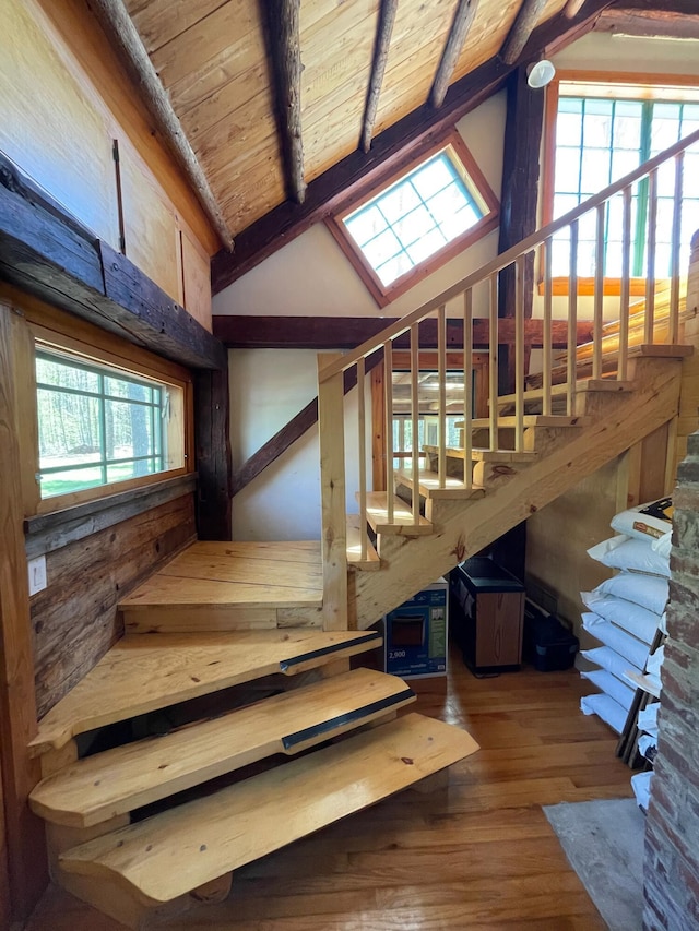 staircase featuring wood ceiling and wood finished floors