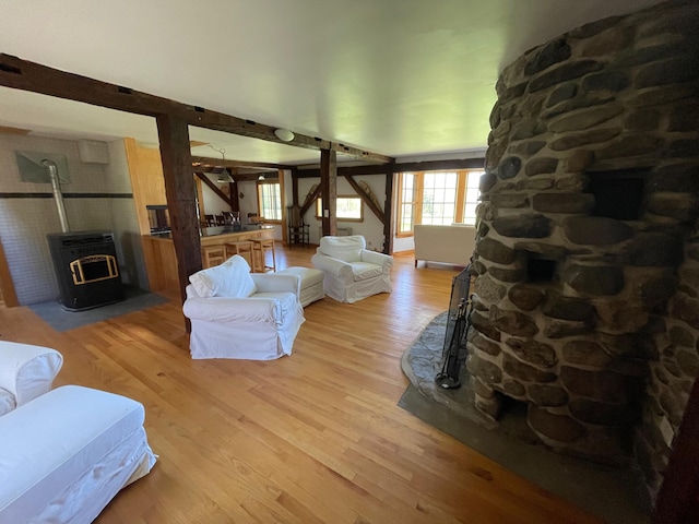 living area featuring a wood stove and light wood finished floors