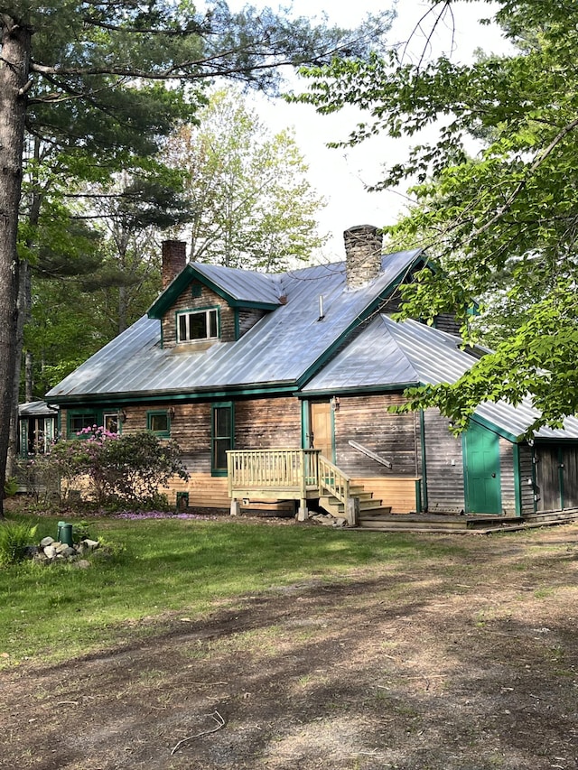 25 Deer Wander Ridge Rd, Anson, ME 04911 - back of house with a chimney, a metal roof, and a lawn