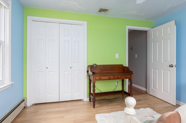 7 Canterbury Pines Dr, Gorham, ME 04038 - bedroom featuring a baseboard radiator, a closet, light wood-style flooring, and baseboards