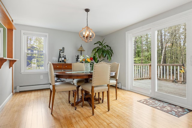 7 Canterbury Pines Dr, Gorham, ME 04038 - dining area featuring a baseboard heating unit, a chandelier, light wood-type flooring, and baseboards