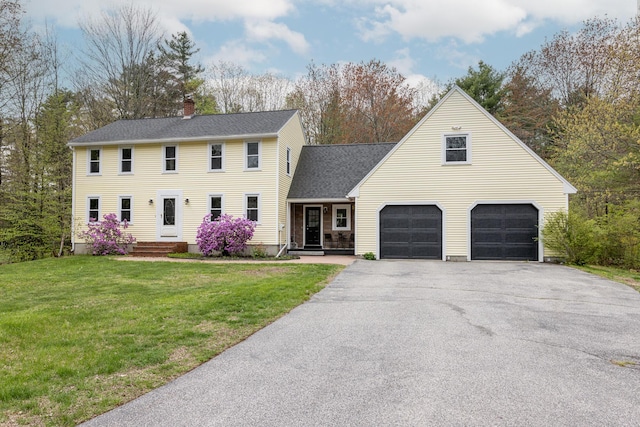 7 Canterbury Pines Dr, Gorham, ME 04038 - colonial inspired home featuring asphalt driveway, a chimney, a front yard, an attached garage, and roof with shingles