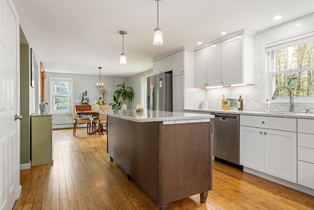 7 Canterbury Pines Dr, Gorham, ME 04038 - kitchen featuring appliances with stainless steel finishes, a baseboard radiator, light wood finished floors, light stone countertops, and recessed lighting