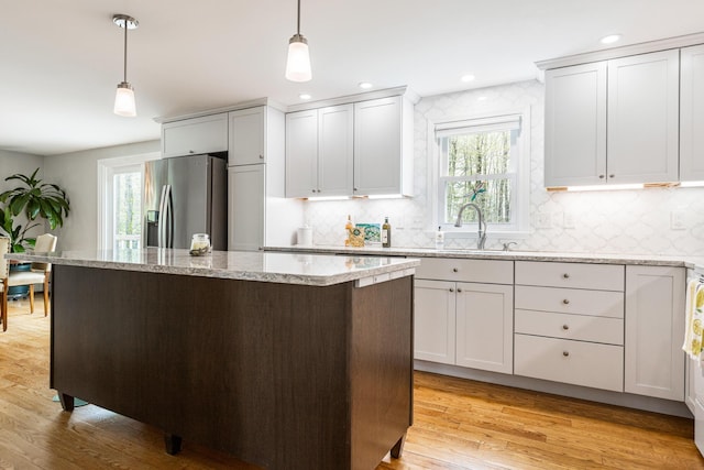 7 Canterbury Pines Dr, Gorham, ME 04038 - kitchen featuring stainless steel fridge with ice dispenser, a sink, a center island, tasteful backsplash, and recessed lighting