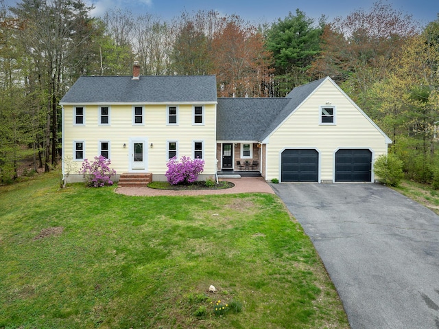 7 Canterbury Pines Dr, Gorham, ME 04038 - colonial home with a chimney, asphalt driveway, a front lawn, and roof with shingles