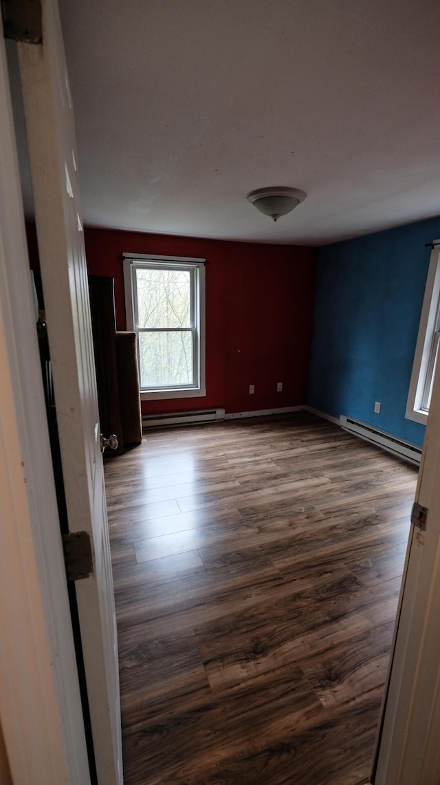 1 Nichols St, Bath, ME 04530 - spare room with a baseboard heating unit, dark wood-type flooring, and baseboards
