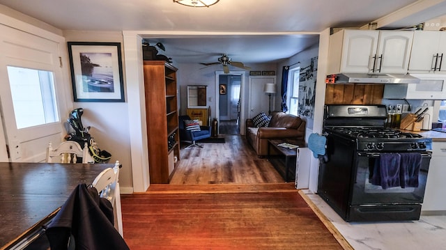 1 Nichols St, Bath, ME 04530 - kitchen featuring black gas stove, healthy amount of natural light, ceiling fan, and white cabinetry