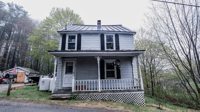 1 Nichols St, Bath, ME 04530 - traditional style home with covered porch, a standing seam roof, a chimney, and metal roof