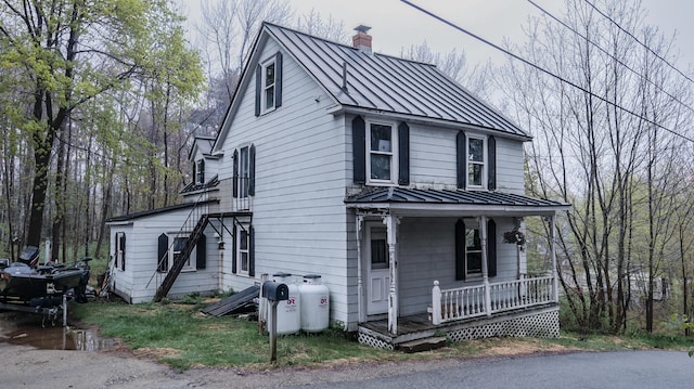 1 Nichols St, Bath, ME 04530 - view of front of house featuring a standing seam roof, metal roof, a porch, and a chimney