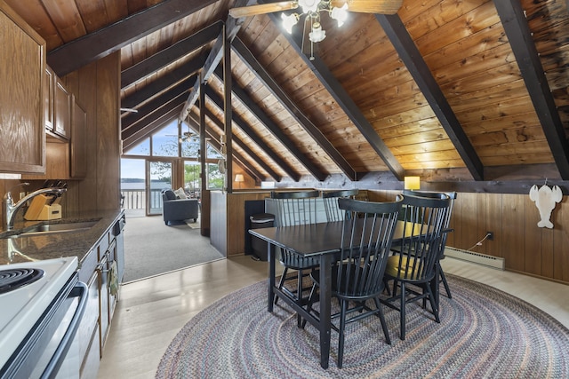 489 Leisure Ln, Frye Island, ME 04071 - dining space with wooden ceiling, a baseboard radiator, ceiling fan, light wood-style flooring, and wooden walls