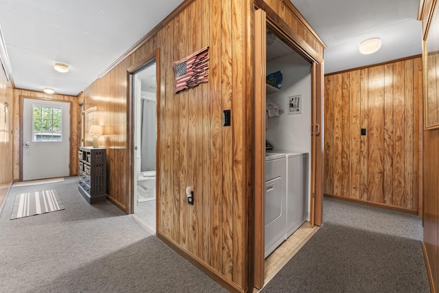 489 Leisure Ln, Frye Island, ME 04071 - corridor with wood walls, washing machine and dryer, light carpet, and baseboards