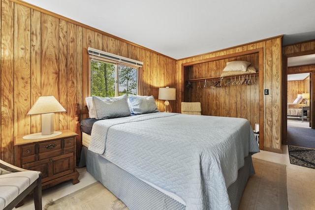 489 Leisure Ln, Frye Island, ME 04071 - bedroom with wood walls, a closet, and ornamental molding