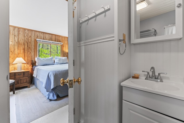 489 Leisure Ln, Frye Island, ME 04071 - ensuite bathroom featuring wooden walls and vanity