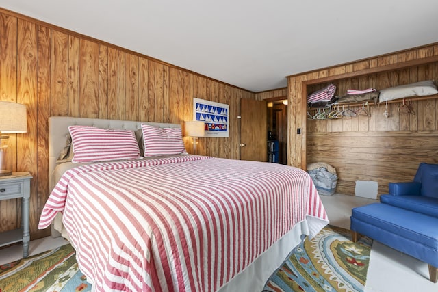 489 Leisure Ln, Frye Island, ME 04071 - bedroom featuring wooden walls, concrete flooring, and ornamental molding