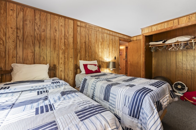 489 Leisure Ln, Frye Island, ME 04071 - carpeted bedroom featuring wooden walls and a closet