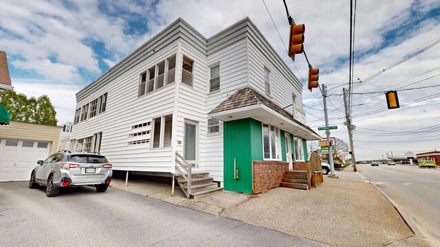view of front facade featuring entry steps and a garage