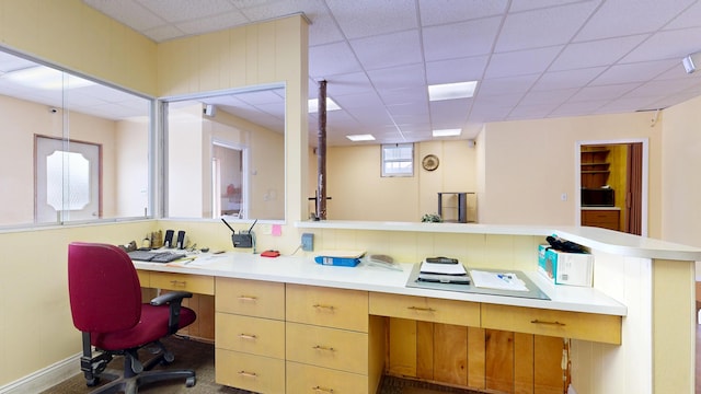 office area featuring built in desk and a paneled ceiling