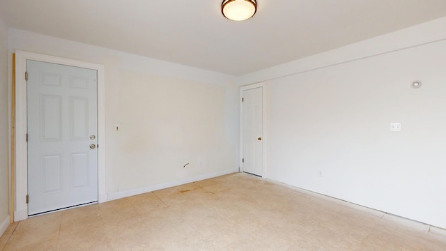 empty room with baseboards
