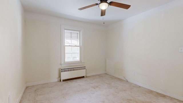 unfurnished room with radiator heating unit, a ceiling fan, and baseboards