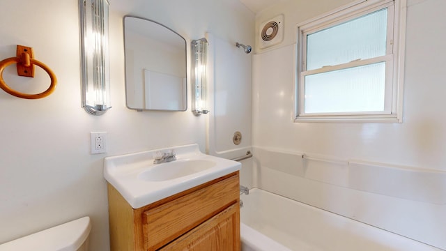full bathroom featuring toilet, vanity, and shower / washtub combination