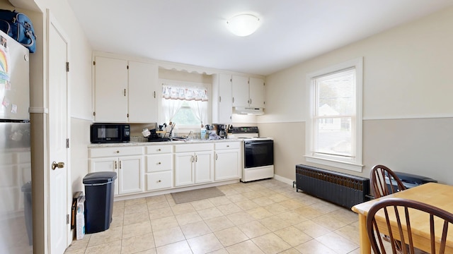 kitchen featuring electric stove, black microwave, under cabinet range hood, and white cabinets
