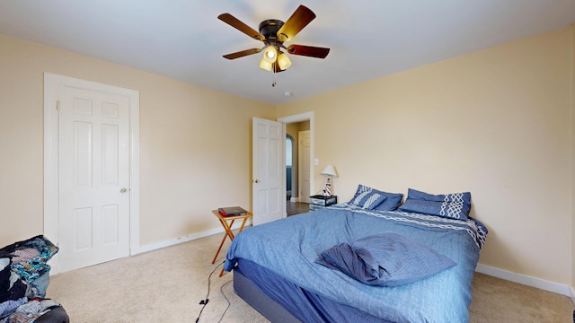 carpeted bedroom featuring baseboards and ceiling fan