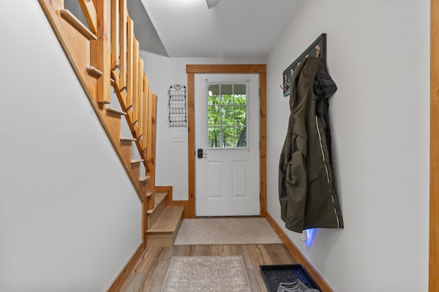 186 Ridge Rd, Frye Island, ME 04071 - doorway with light wood finished floors, stairway, and baseboards