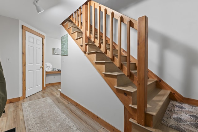 186 Ridge Rd, Frye Island, ME 04071 - staircase with baseboards and wood finished floors
