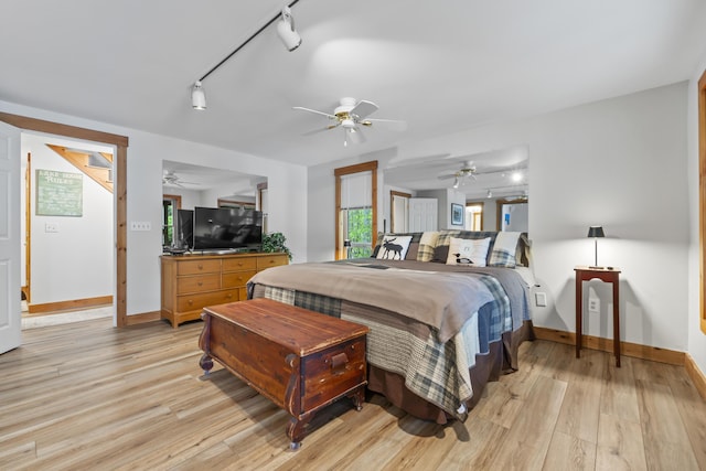 186 Ridge Rd, Frye Island, ME 04071 - bedroom with rail lighting, baseboards, light wood finished floors, and ceiling fan