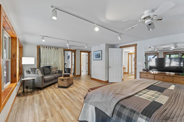 186 Ridge Rd, Frye Island, ME 04071 - bedroom featuring rail lighting, light wood-type flooring, and baseboards