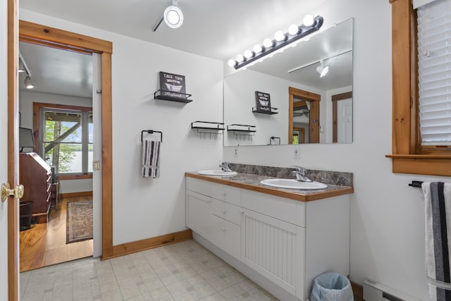 186 Ridge Rd, Frye Island, ME 04071 - full bathroom with a baseboard heating unit, double vanity, baseboards, tile patterned floors, and track lighting