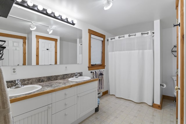 186 Ridge Rd, Frye Island, ME 04071 - full bath featuring double vanity, a baseboard radiator, curtained shower, and baseboards