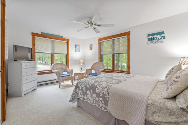 186 Ridge Rd, Frye Island, ME 04071 - carpeted bedroom featuring multiple windows, a ceiling fan, and a baseboard radiator