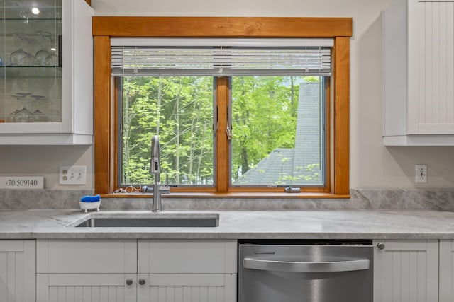 186 Ridge Rd, Frye Island, ME 04071 - kitchen featuring dishwasher, a sink, white cabinets, light stone counters, and glass insert cabinets