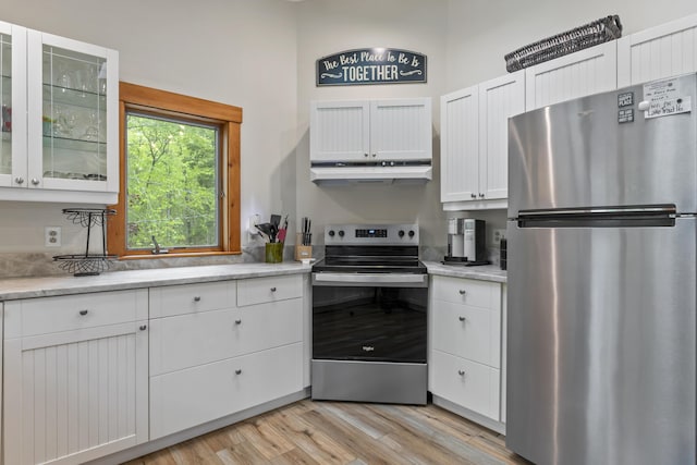 186 Ridge Rd, Frye Island, ME 04071 - kitchen with stainless steel appliances, under cabinet range hood, light wood finished floors, white cabinets, and glass insert cabinets