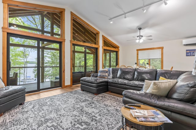 186 Ridge Rd, Frye Island, ME 04071 - living area featuring track lighting, vaulted ceiling, an AC wall unit, wood finished floors, and ceiling fan
