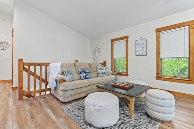 186 Ridge Rd, Frye Island, ME 04071 - living room featuring wood finished floors, lofted ceiling, and baseboards