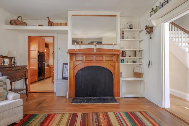 6 Sea St, Northeast Harbor, Mount Desert, ME 04662 - living room featuring a fireplace, baseboards, and stairs
